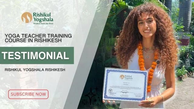 Yoga teacher training student in Rishikesh holding her Rishikul Yogshala certificate